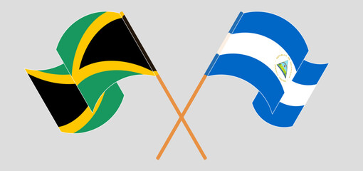 Crossed and waving flags of Jamaica and Nicaragua