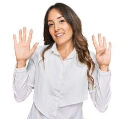 Young brunette woman wearing casual clothes showing and pointing up with fingers number nine while...