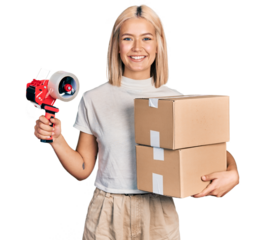 Beautiful young blonde woman holding packing tape and cardboard boxes smiling with a happy and cool smile on face. showing teeth.