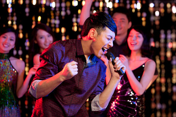 Young Chinese singing karaoke