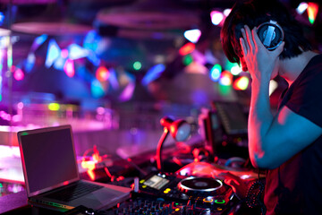 Chinese DJ doing record scratching in nightclub