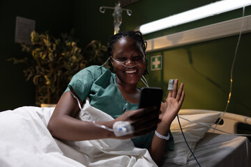 Hospital scene with the African woman, smiling and waving to the camera, saying hello.