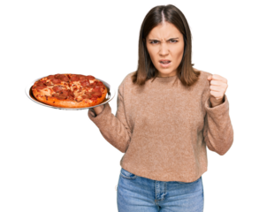 Young beautiful woman holding italian pizza annoyed and frustrated shouting with anger, yelling crazy with anger and hand raised