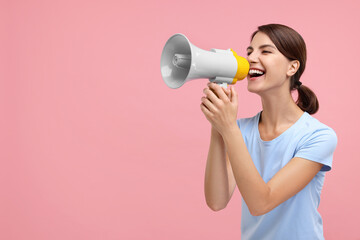 Special promotion. Young woman shouting in megaphone on pink background, space for text