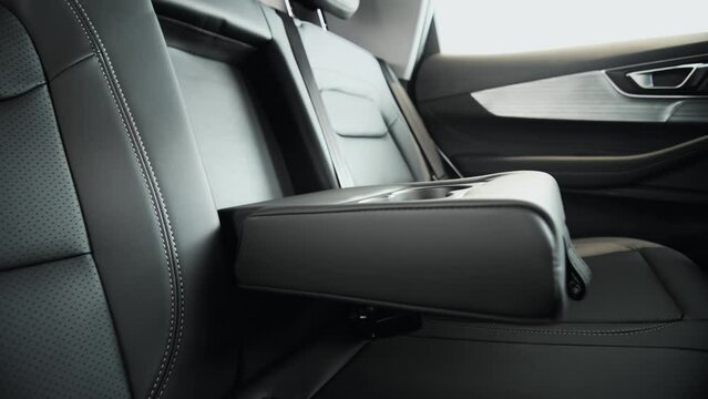Cupholders in the armrest. Command Central, The Intersection of Luxury and Control in a Sedan Cockpit