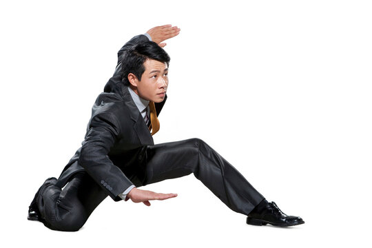 Businessman in martial arts crouching stance