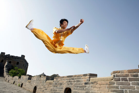 Man Practicing Martial Arts In Traditional Dress On The Great Wall Of China