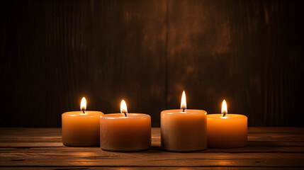 Obraz na płótnie Canvas Three burning candles on a table