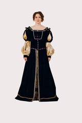 Fototapeta premium Portrait of a young aristocratic woman dressed in a medieval dress on white background. Front view