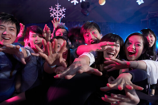 A Crowd Of Excited Young People At A Music Concert