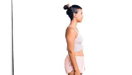 Young woman wearing sportswear looking to side, relax profile pose with natural face with confident smile.