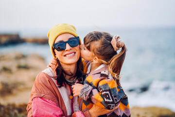 portrait of a mother in love with her child on the beach in cyprus