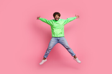 Fototapeta na wymiar Full body size photo of carefree sporty arabian man wear green sweatshirt with jeans he look like star isolated on pink color background