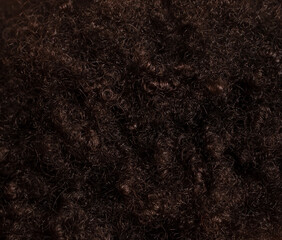 Black curly hair as an abstract background. Texture