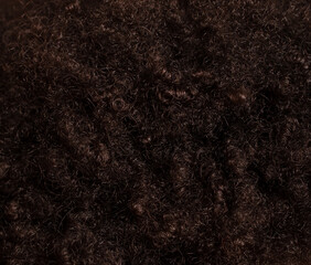Black curly hair as an abstract background. Texture