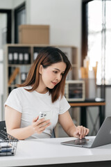 Businessman using Tablet and laptop computer in office. Happy woman, entrepreneur, small business owner working online.