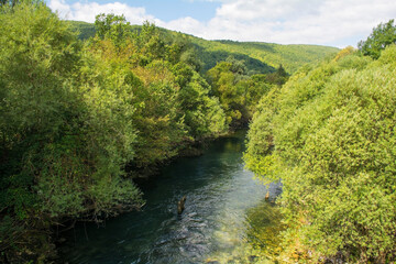 The River Unac as it flows through Martin Brod, Bihac, in the Una National Park. Una-Sana Canton,...