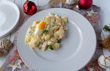 German potato salad for christmas eve. Served on a festive plate for side dish on a table  with decoration
