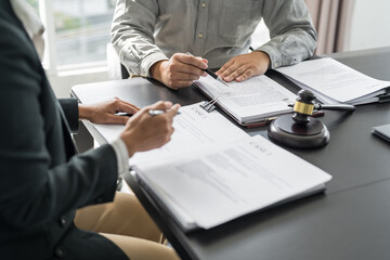 Lawyer Legal counsel presents to the client a signed contract with gavel and legal law. justice and lawyer Business partnership meeting concept