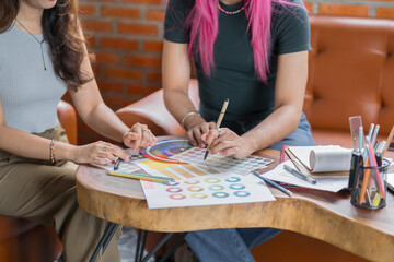 Fototapeta premium LGBTQ+ transgender man Beautiful Authentic Specialist&nbsp;with Pink Hair and Non-binary trans working together Working Design in creative workplace team work colleagues Gender equality