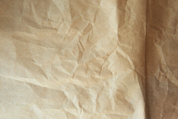 Closeup Thin kraft creased or crushed brown tone color environmental friendly paper texture...