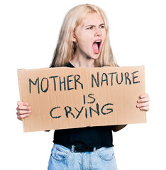 Young caucasian woman holding mother nature is crying protest cardboard banner angry and mad...
