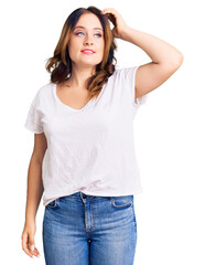 Fototapeta premium Young beautiful caucasian woman wearing casual white tshirt smiling confident touching hair with hand up gesture, posing attractive and fashionable