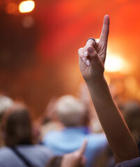 Closeup, hand and person with music festival, cheering and concert with blur background, party and...