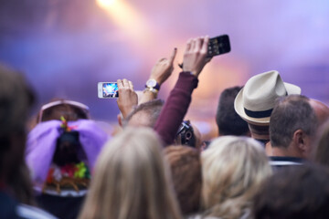 People, festival and crowd in music concert, cellphones and audience for event, entertainment and...
