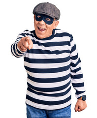 Fototapeta premium Senior handsome man wearing burglar mask and t-shirt pointing displeased and frustrated to the camera, angry and furious with you