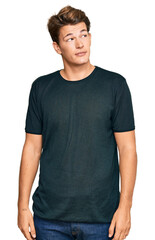 Obraz premium Handsome caucasian man wearing casual clothes smiling looking to the side and staring away thinking.