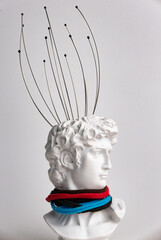 Antique male David statue's head with manual Massager for head isolated on a white background. 3d...