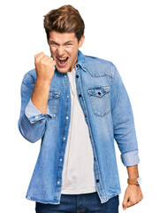 Handsome caucasian man wearing casual denim jacket angry and mad raising fist frustrated and furious while shouting with anger. rage and aggressive concept.