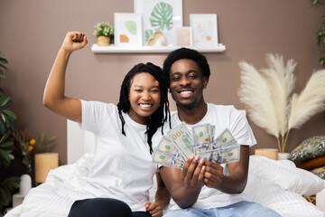 Smiled young African American dark skinned couple man and woman wearing casual white t-shirt...