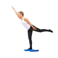 Fototapeta premium Balance, health and stretching with woman on disk in studio for workout, mindfulness or exercise. Wellness, challenge and training with person on white background for flexibility and aerobics