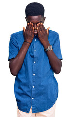Young african american man wearing casual clothes rubbing eyes for fatigue and headache, sleepy and...