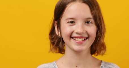Portrait happy girl teenage in yellow studio background