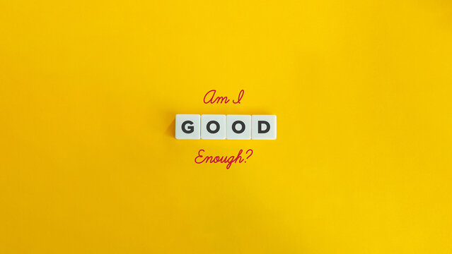 Am I Good Enough Question and Concept. Introspection, Self-doubt, Imposter Syndrome. Block Letter Tiles and Cursive Text on Yellow Background. Minimalist Aesthetics.