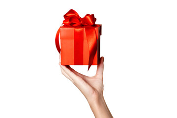 The theme of celebrations and gifts: hand holding a gift wrapped in red box with red bow isolated on white or png transparent background