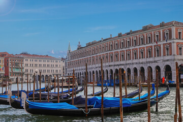 Fototapeta na wymiar Venice postcard with gondolas, beautiful gondolas moored in the Grand Canal of Venice, Veneto, Italy