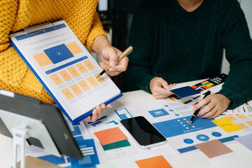  UX developer and ui designer brainstorming about mobile app interface wireframe design with...