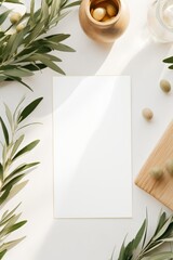 white paper card template on beige color table with olive tree leaf frame nature summertime...
