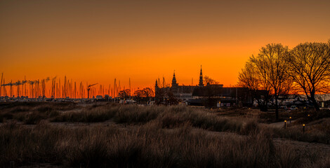 Panoramic view of Kronborg Castle and a silhouette at sunrise, Elsinore, Denmark - obrazy, fototapety, plakaty