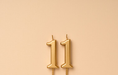 11 years celebration festive background made with golden candles in the form of number eleven....