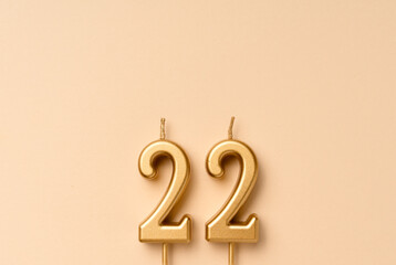 22 years celebration festive background made with golden candles in the form of number twenty-two....