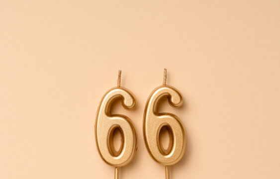 66 years celebration festive background made with golden candles in the form of number sixty-six. Universal holiday banner with copy space.