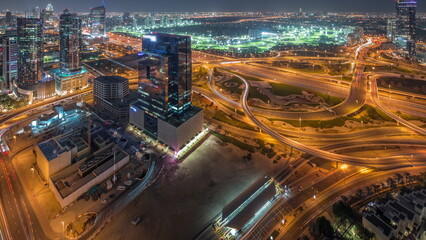 Huge highway crossroad junction between JLT district and media city aerial day to night timelapse.