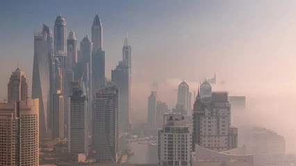 Aluminium Prints Morning with fog View of various skyscrapers in tallest residential block in Dubai Marina aerial timelapse