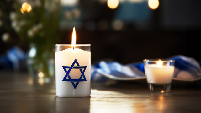 Burning candle with the Star of David arranged on a table convey the concept of International Holocaust Remembrance Day. January 27, Memory Day, commemoration of the Holocaust. Copy space. Banner