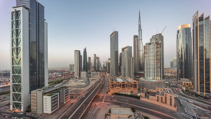 Aerial panoramic view of Dubai Downtown skyline with many towers day to night timelapse.